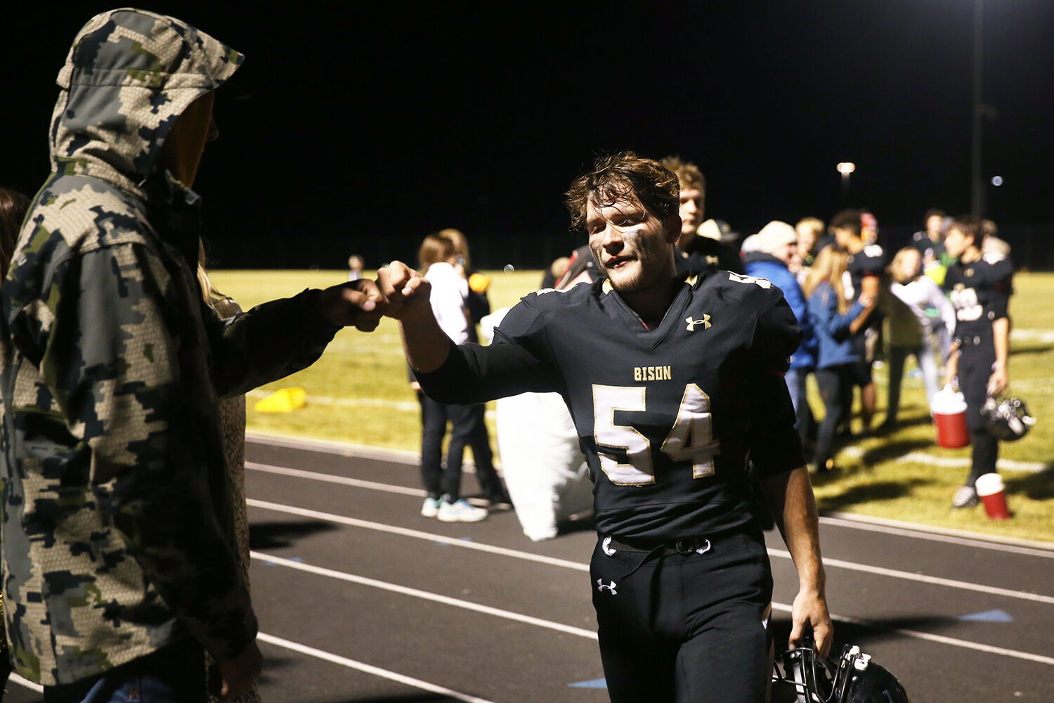Tucker Giles fist bumps injured senior Hunter Stone after the conclusion